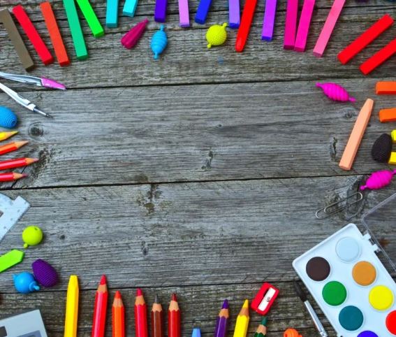 picture of some school supplies on a wooden deck.