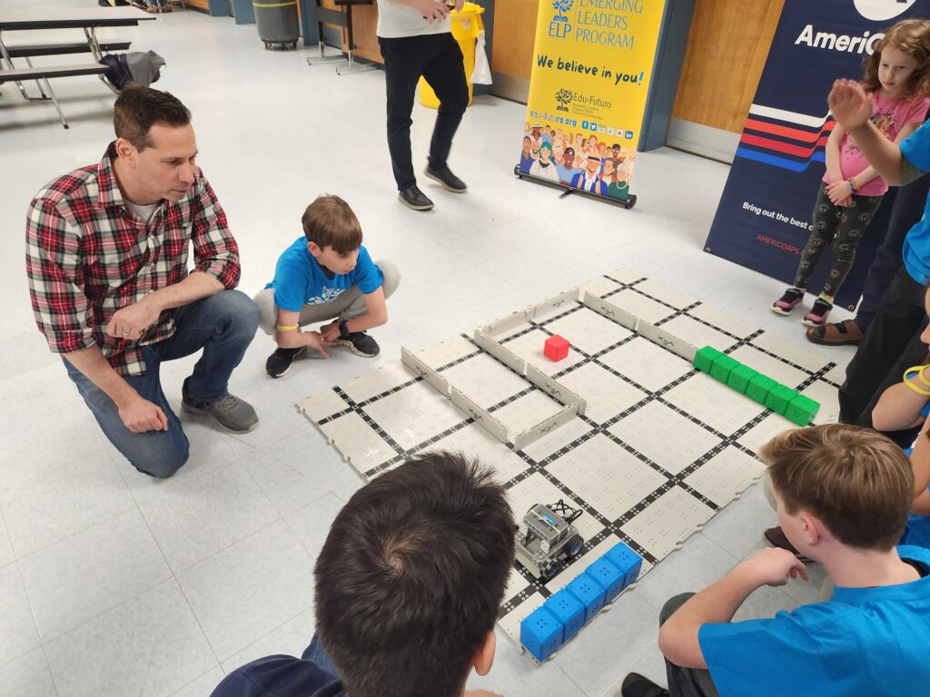 Students working with computer programming cars